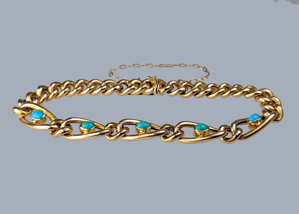 Victorian 9ct yellow gold curb link bracelet featuring oval openwork links set with turquoise cabochons and fitted with a safety chain. View V