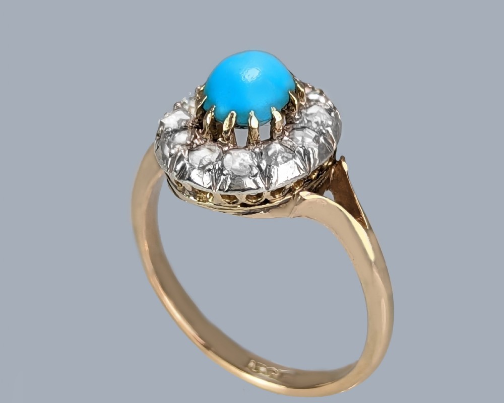 A Victorian 15ct yellow gold ring set with a bright blue oval turquoise cabochon within a halo of rose-cut diamonds. View III