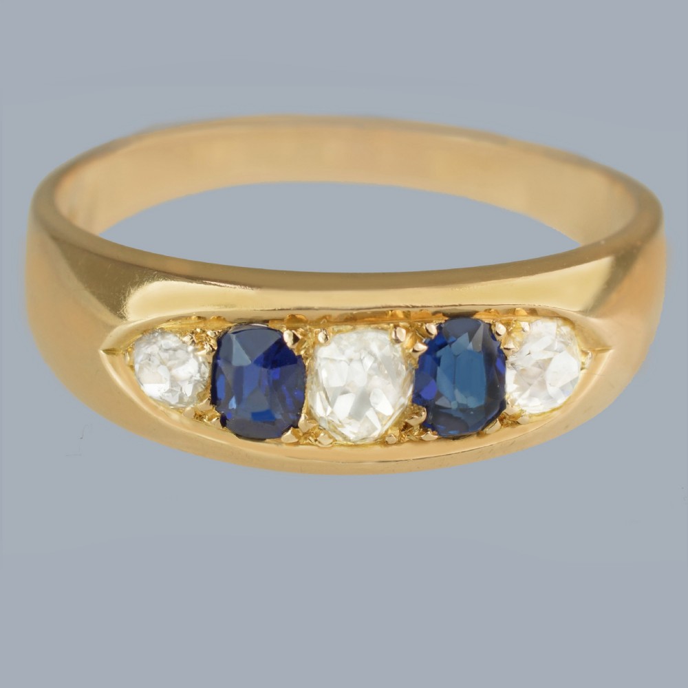 A late Victorian 18ct gold boat ring set horizontally with alternating blue sapphires and white diamonds. View II