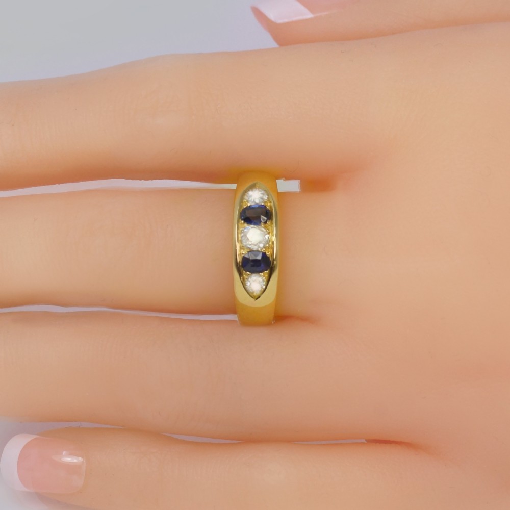 A late Victorian 18ct gold boat ring set horizontally with alternating blue sapphires and white diamonds. View III