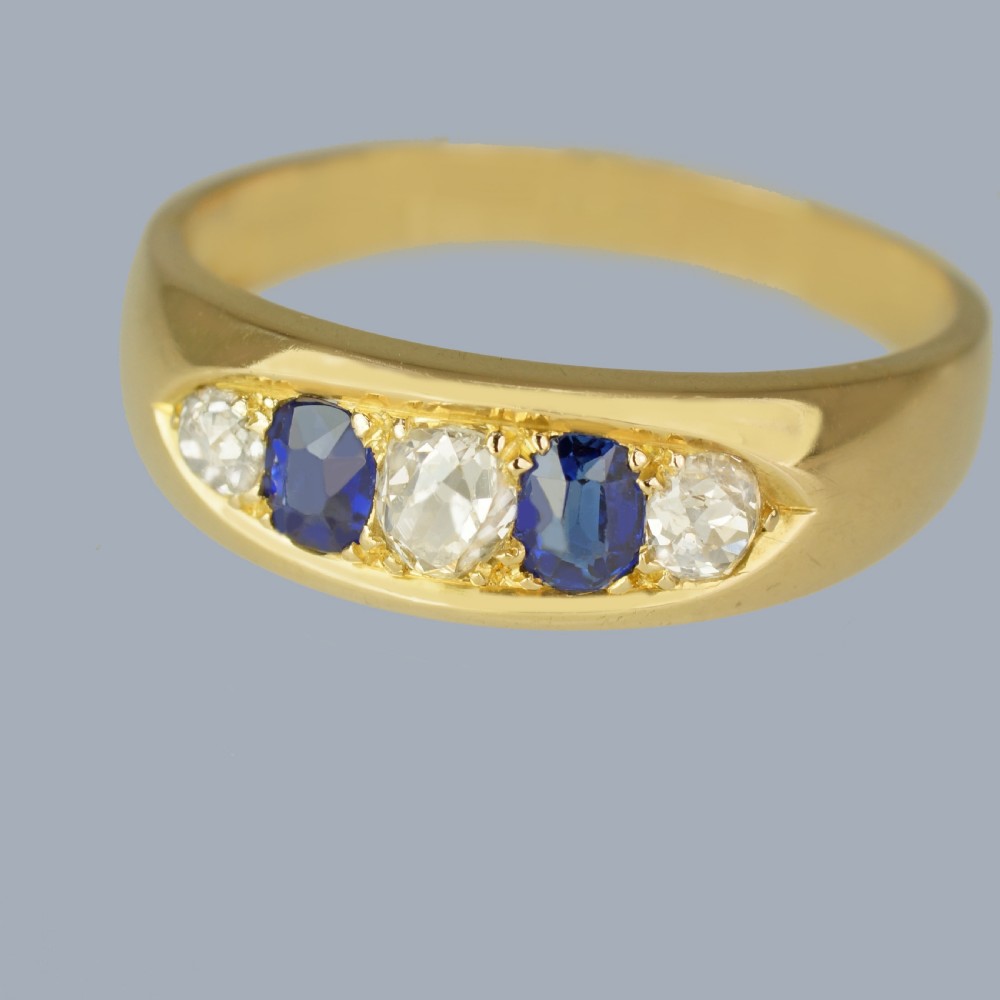 A late Victorian 18ct gold boat ring set horizontally with alternating blue sapphires and white diamonds. View VI