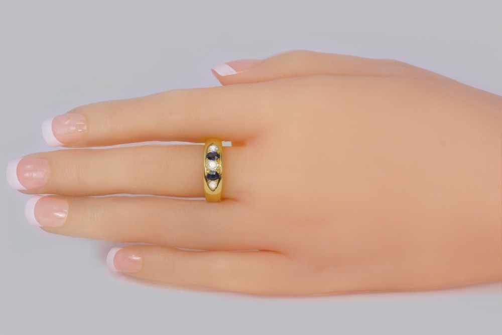 A late Victorian 18ct gold boat ring set horizontally with alternating blue sapphires and white diamonds. View VII