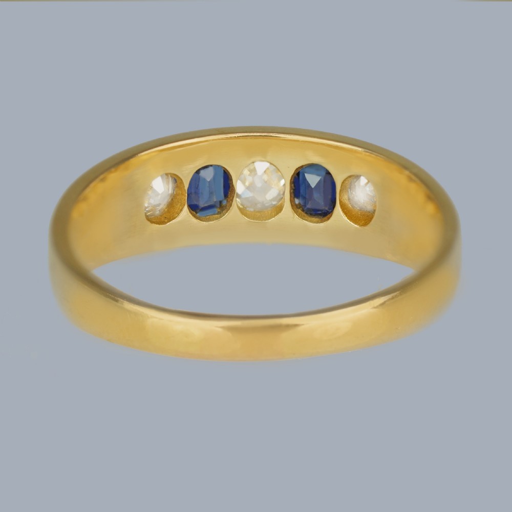 A late Victorian 18ct gold boat ring set horizontally with alternating blue sapphires and white diamonds. View VIII