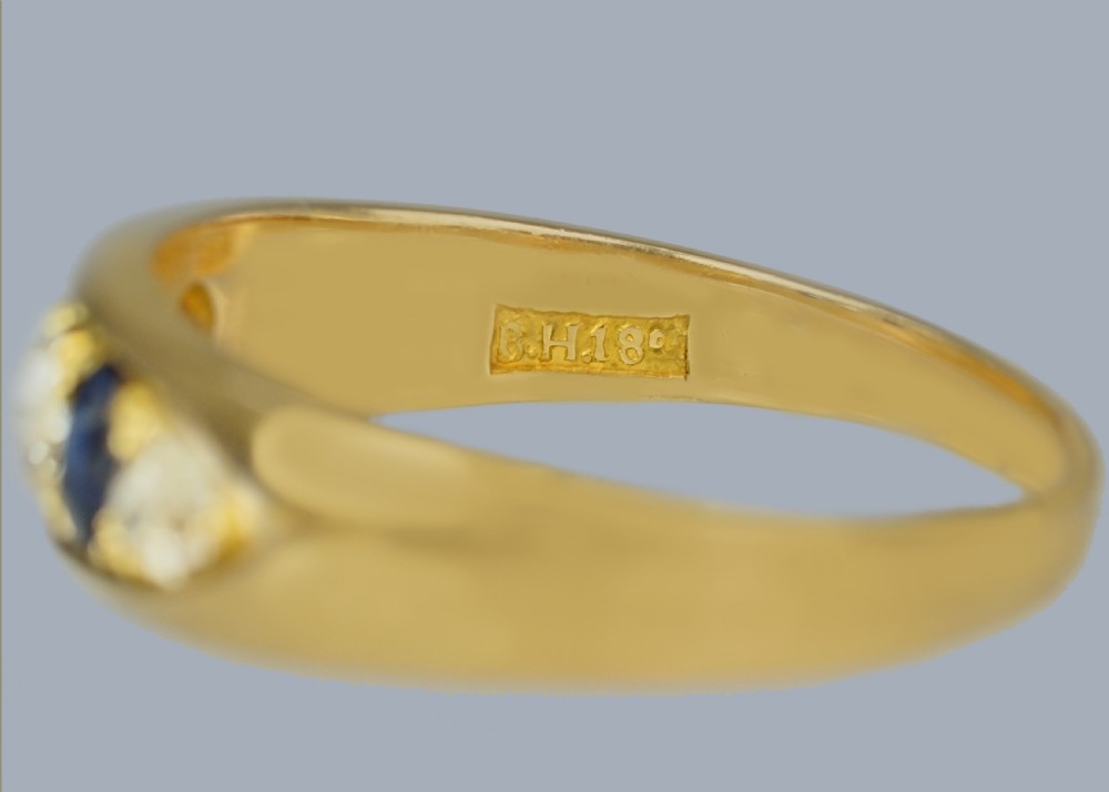 A late Victorian 18ct gold boat ring set horizontally with alternating blue sapphires and white diamonds. View IX