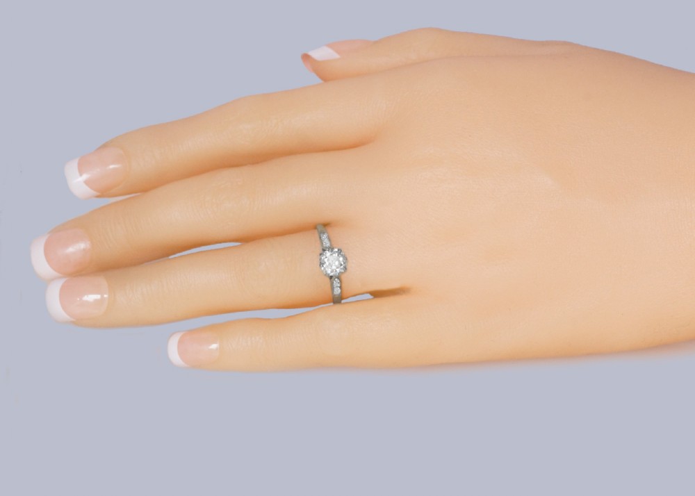 An Edwardian style diamond solitaire ring featuring a round old European cut centre stone with accent diamonds set into the shoulders. View III