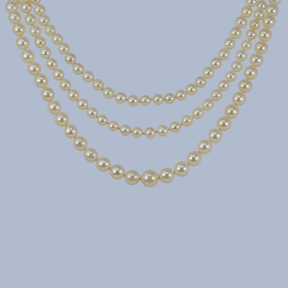 A continuous fifty-inch strand of uniform cream cultured pearls with a rectangular nine-carat gold clasp inset with small pearls. View VI