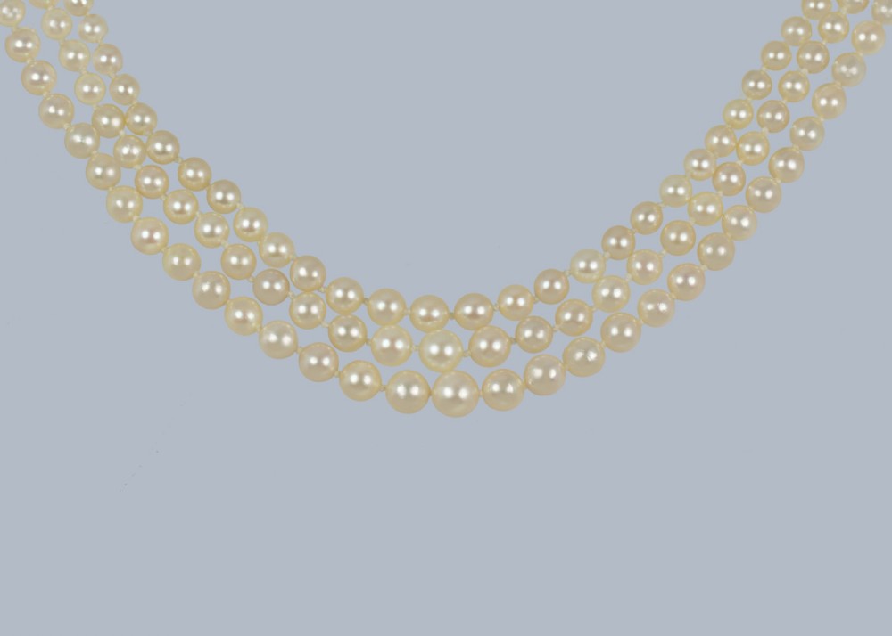 An Art Deco triple-strand cultured pearl necklace with a square geometric clasp set with brilliant diamonds. View IX