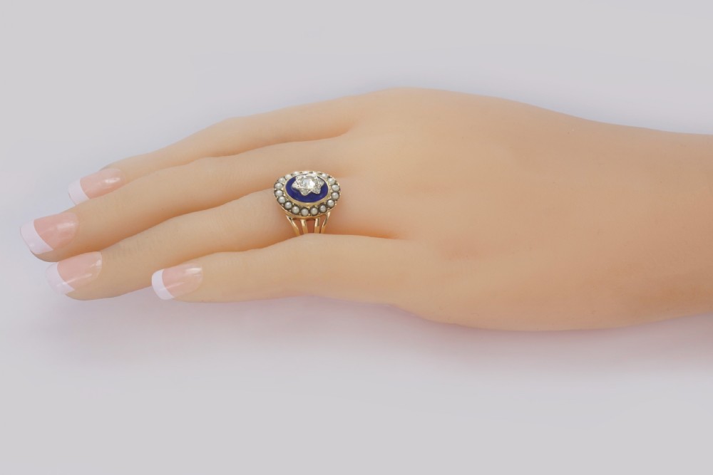 An antique Georgian gold ring featuring a central rose-cut diamond star motif set over cobalt blue glass, surrounded by a border of seed pearls and finished with a split shank band. View XIII