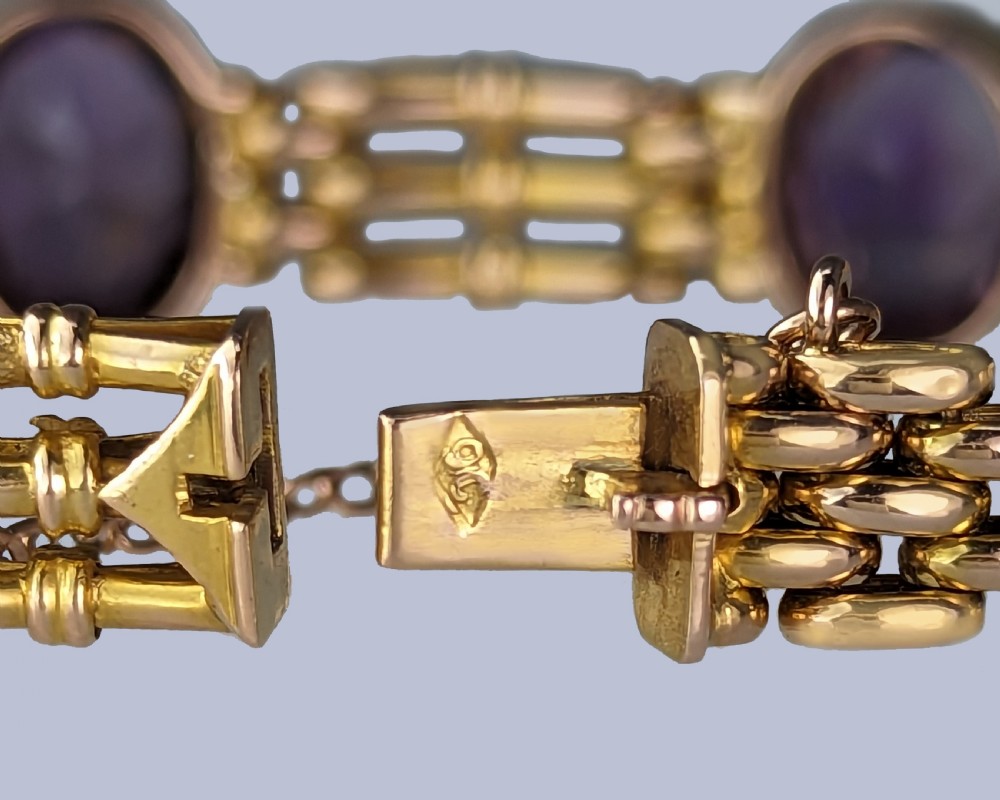 Victorian 9ct gold gate link bracelet set with six oval faceted purple amethyst gemstones and fitted with a safety chain. View V