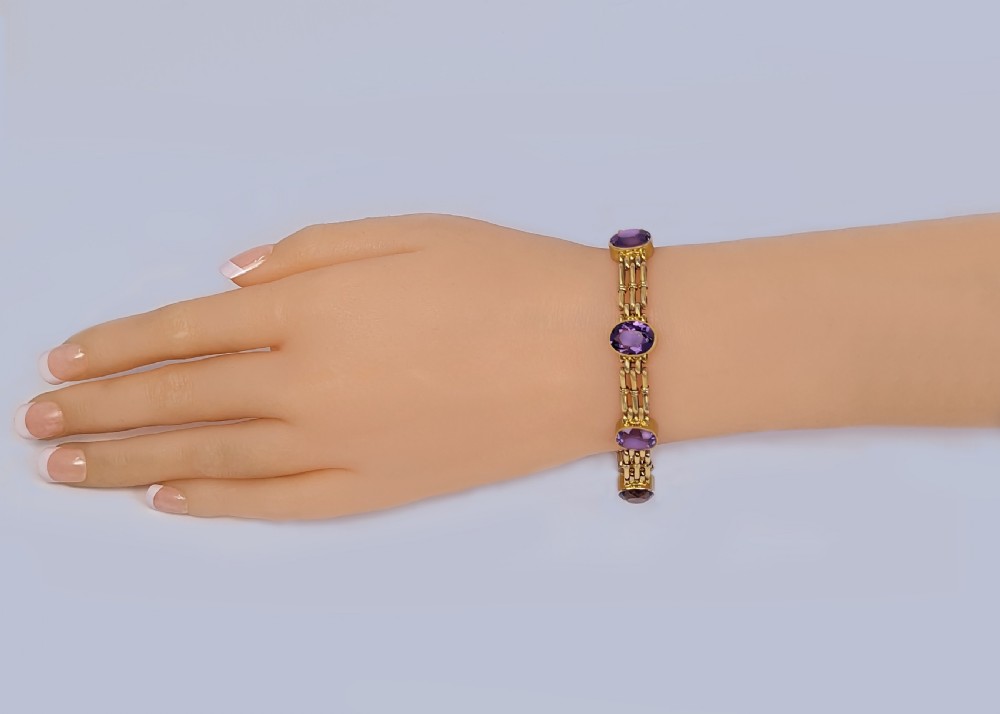 Victorian 9ct gold gate link bracelet set with six oval faceted purple amethyst gemstones and fitted with a safety chain. View IX
