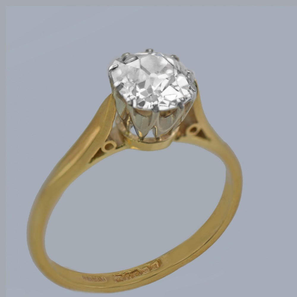 A vintage 18ct yellow gold solitaire ring featuring a 1.3-carat old cushion-cut diamond held in white metal claw settings. View II
