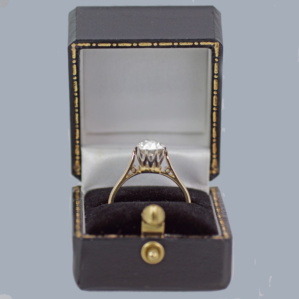 A vintage 18ct yellow gold solitaire ring featuring a 1.3-carat old cushion-cut diamond held in white metal claw settings. View XIV