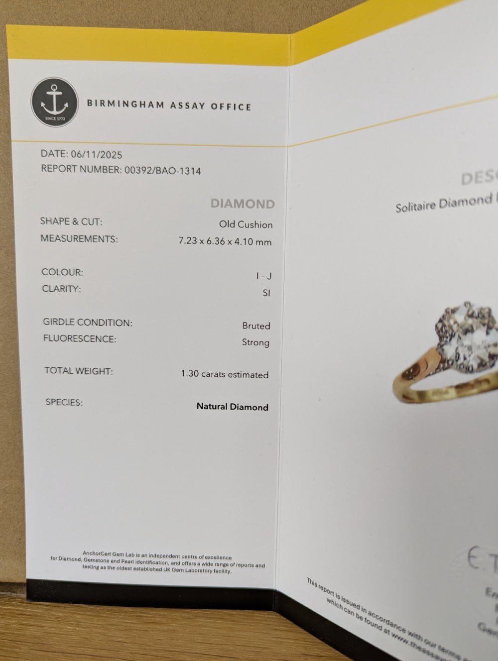 A vintage 18ct yellow gold solitaire ring featuring a 1.3-carat old cushion-cut diamond held in white metal claw settings. View XVI