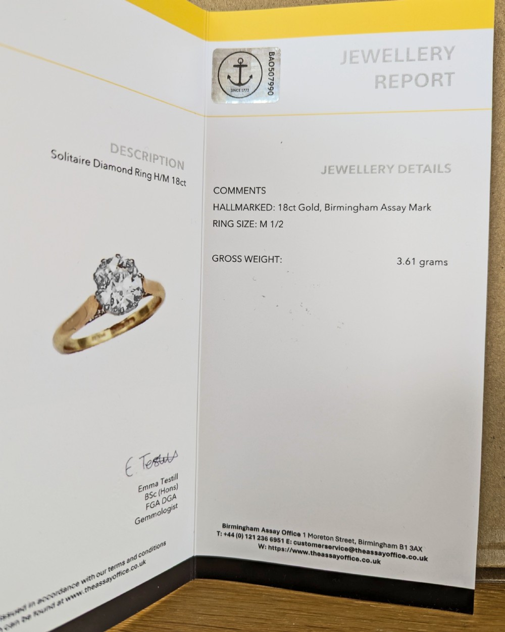 A vintage 18ct yellow gold solitaire ring featuring a 1.3-carat old cushion-cut diamond held in white metal claw settings. View XVII
