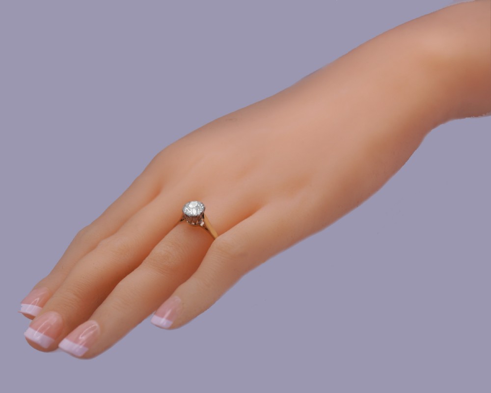 A vintage 18ct yellow gold solitaire ring featuring a 1.3-carat old cushion-cut diamond held in white metal claw settings. View XX