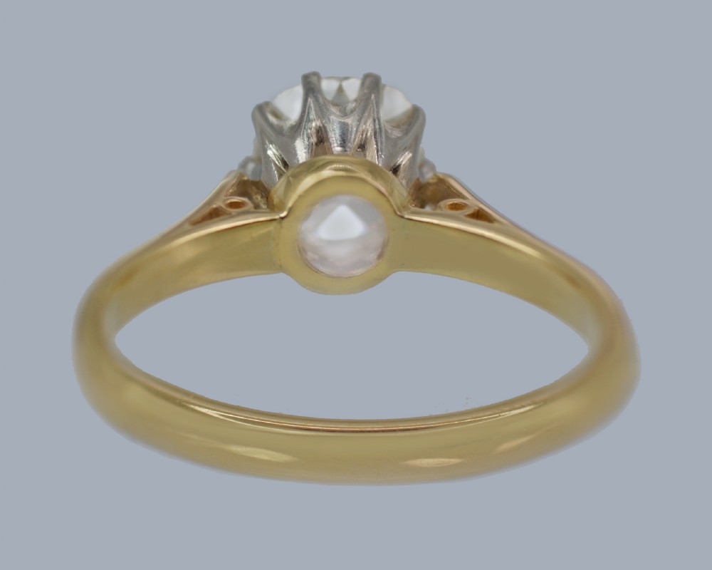 A vintage 18ct yellow gold solitaire ring featuring a 1.3-carat old cushion-cut diamond held in white metal claw settings. View XXIII