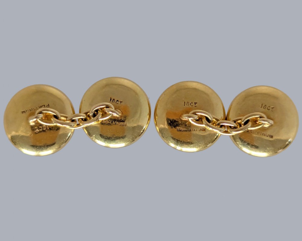 Four round double-sided cufflinks made from mother of pearl discs, each set with a central square blue sapphire framed in platinum and gold. View V