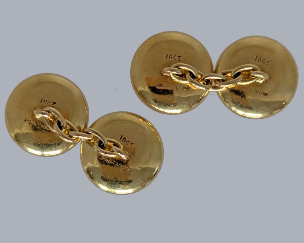 Four round double-sided cufflinks made from mother of pearl discs, each set with a central square blue sapphire framed in platinum and gold. View VI