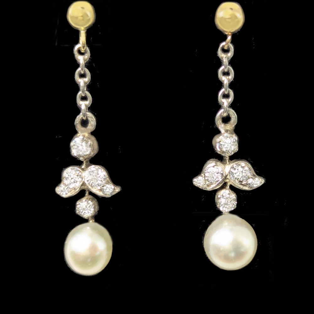 A pair of Edwardian drop earrings featuring gold studs connected by fine chain links to diamond-set foliate motifs and single white pearl drops. View III