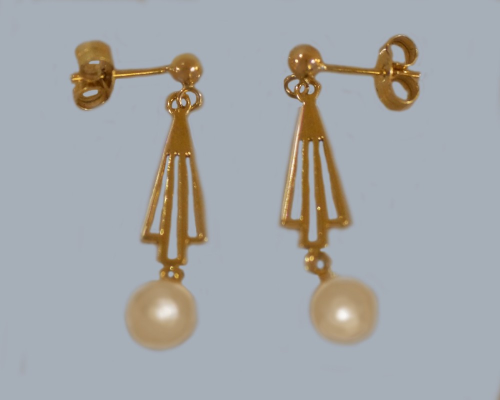 A pair of 9ct yellow gold drop earrings with geometric openwork triangular motifs suspending round cream pearls. View IV