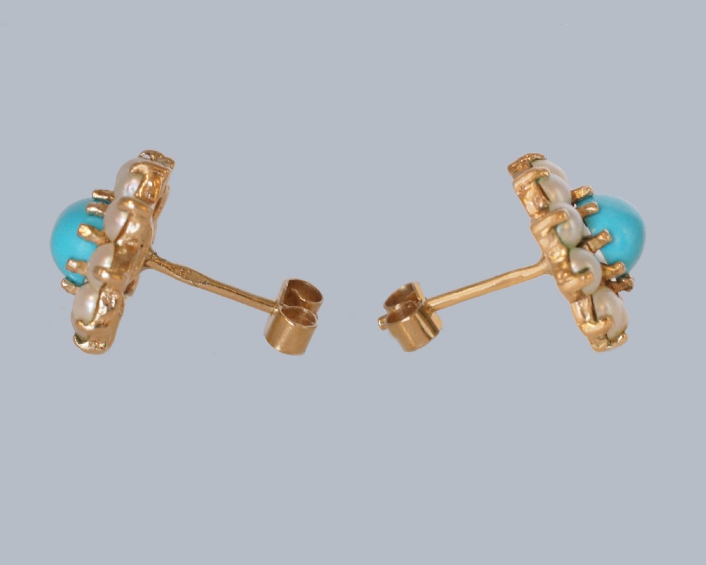A pair of mid-century 9ct gold cluster earrings featuring central oval blue turquoise cabochons surrounded by halos of split pearls. View IV