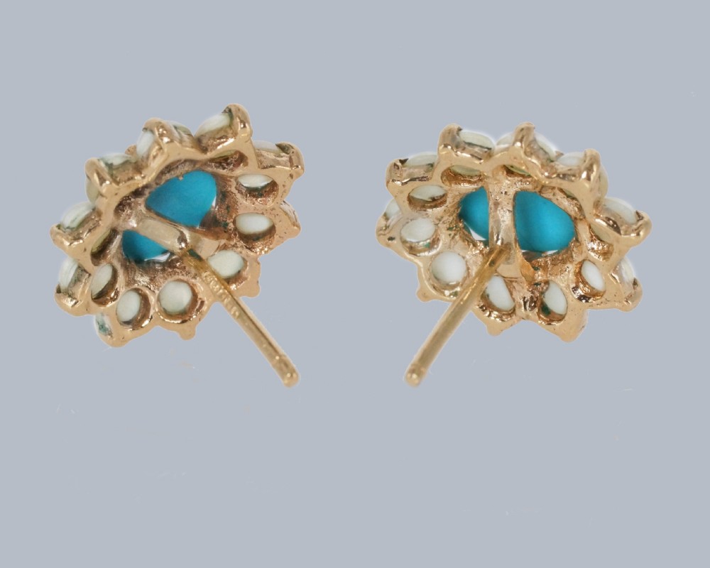A pair of mid-century 9ct gold cluster earrings featuring central oval blue turquoise cabochons surrounded by halos of split pearls. View V