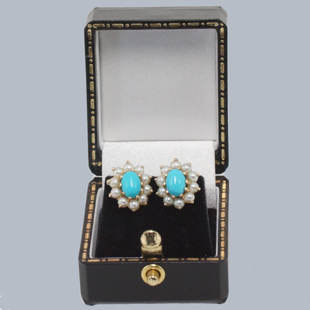 A pair of mid-century 9ct gold cluster earrings featuring central oval blue turquoise cabochons surrounded by halos of split pearls. View VI