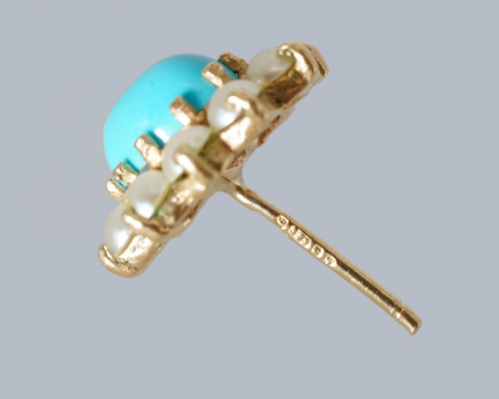 A pair of mid-century 9ct gold cluster earrings featuring central oval blue turquoise cabochons surrounded by halos of split pearls. View VII
