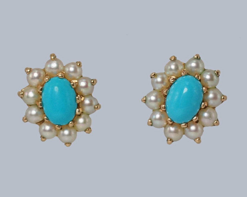 A pair of mid-century 9ct gold cluster earrings featuring central oval blue turquoise cabochons surrounded by halos of split pearls. View VIII