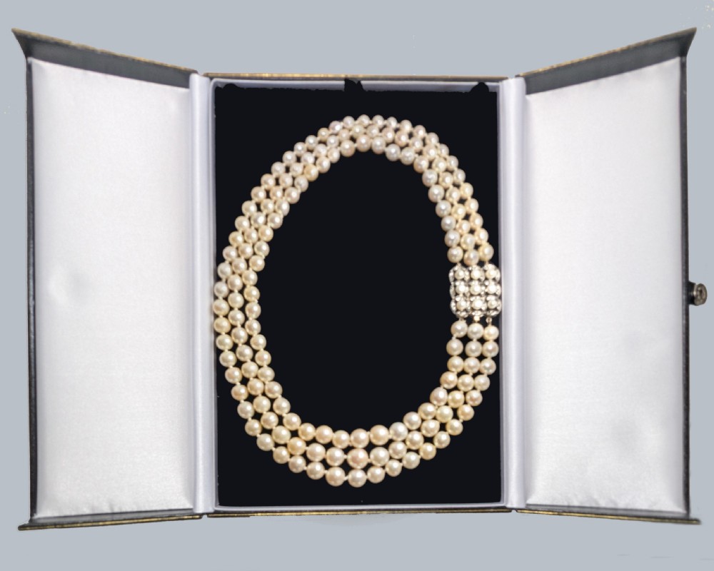 An Art Deco triple-strand cream pearl necklace featuring an ornate square clasp set with rose-cut diamonds and central pearl accents. View XII