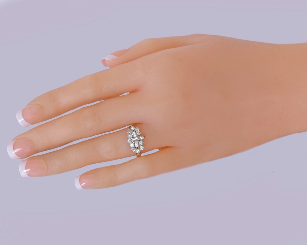 An 18ct yellow gold cluster ring set with an arrangement of baguette cut and round brilliant diamonds. View VIII
