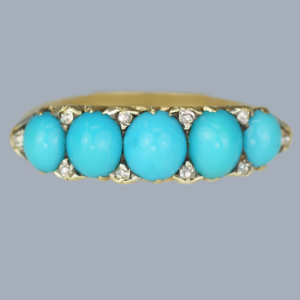 An 18ct yellow gold Victorian ring set with five graduated cabochon turquoise stones punctuated by small diamond points.