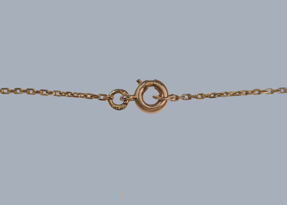 An Edwardian 9ct yellow gold lavalier drop necklace featuring two faceted light blue aquamarines suspended from an openwork bar set with accent diamonds. View VI