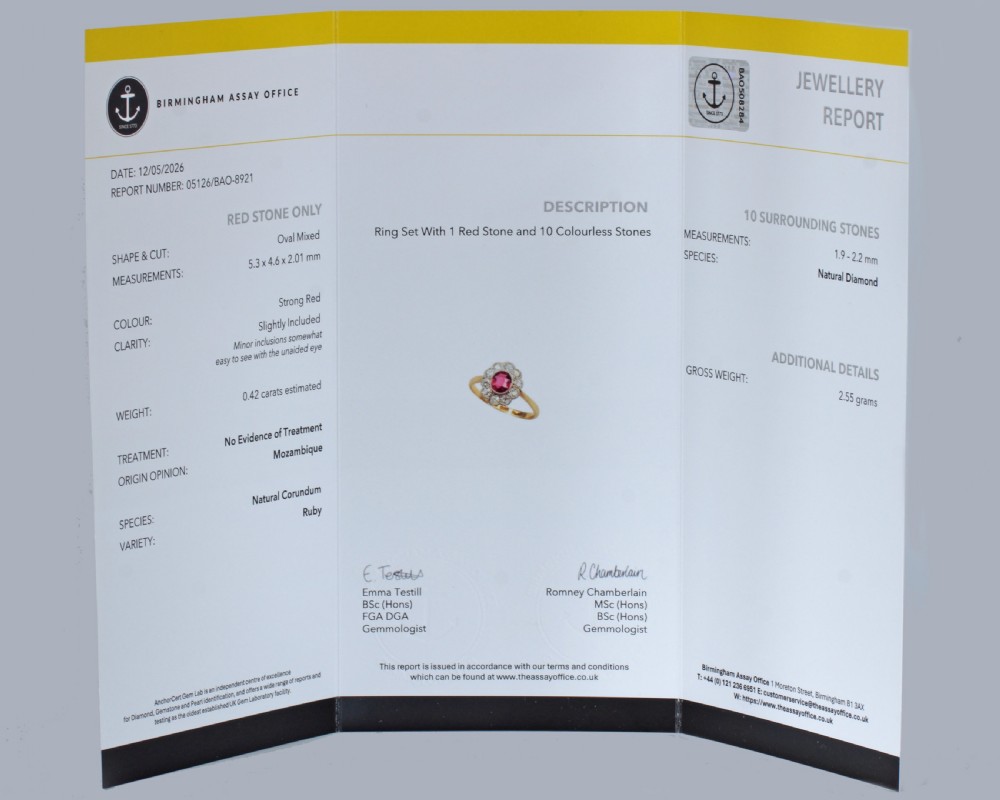 A vintage cluster ring featuring a central oval red ruby surrounded by ten round diamonds set in platinum with an 18ct yellow gold band. View III
