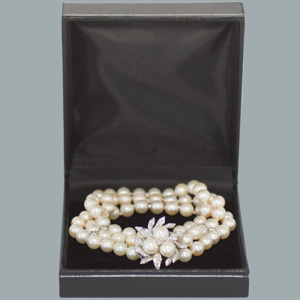 A vintage triple strand cultured pearl bracelet featuring a white gold floral clasp set with small diamonds and central pearls. View VIII