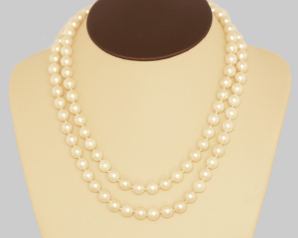 A long single strand of cream-coloured pearls fitted with a geometric 18ct white gold clasp set with diamonds. View XIII
