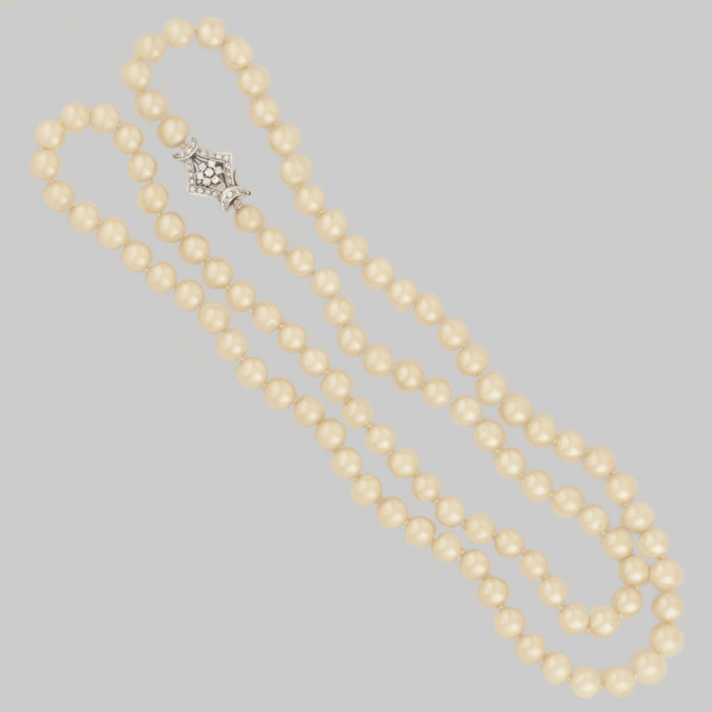 A long single strand of cream-coloured pearls fitted with a geometric 18ct white gold clasp set with diamonds. View XIV