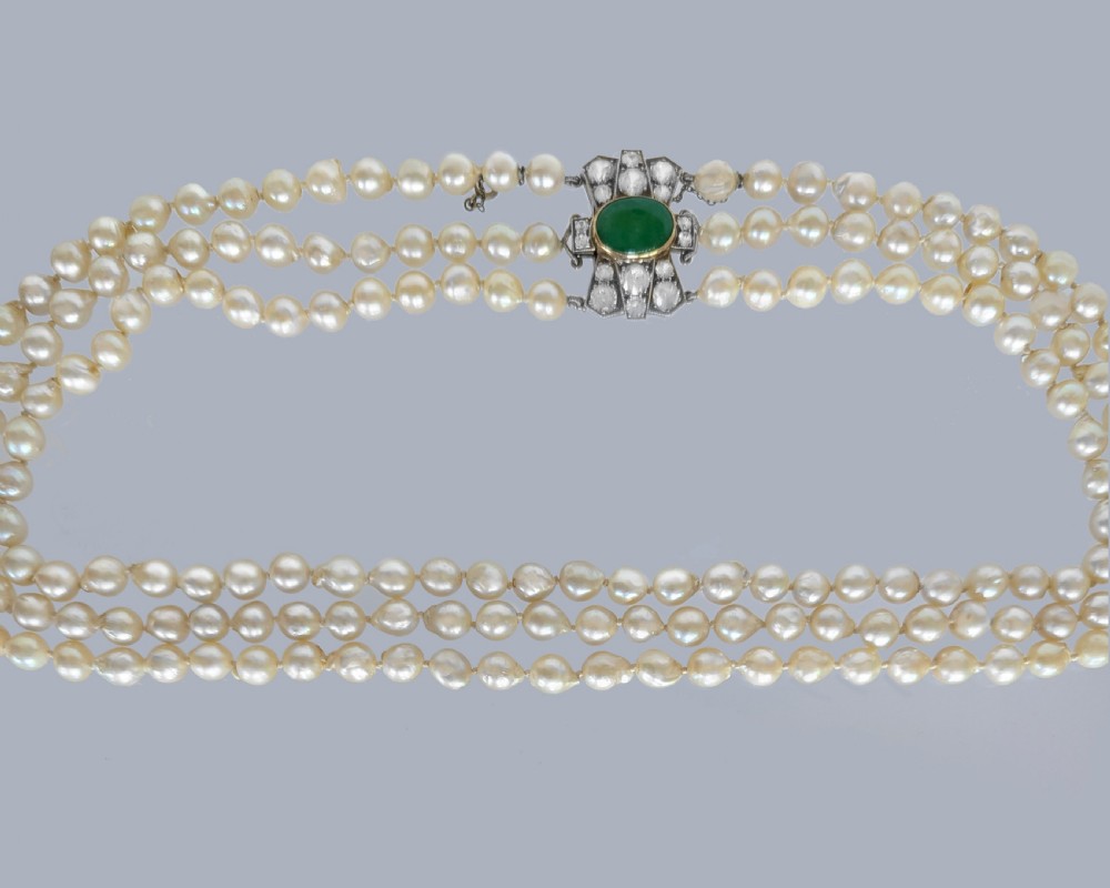 A 1920s triple strand pearl necklace featuring an Art Deco geometric clasp set with an oval green jadeite cabochon. View XV