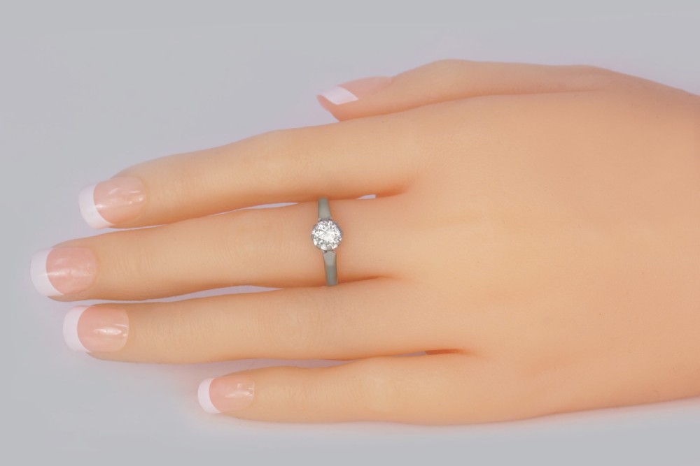 An Art Deco diamond solitaire ring featuring a round central diamond held in a platinum setting on an 18ct yellow gold band. View VIII