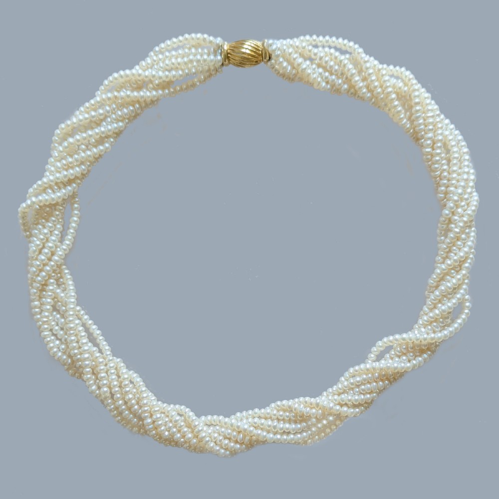 An eight-strand freshwater seed pearl necklace with a fluted yellow gold barrel clasp. View III