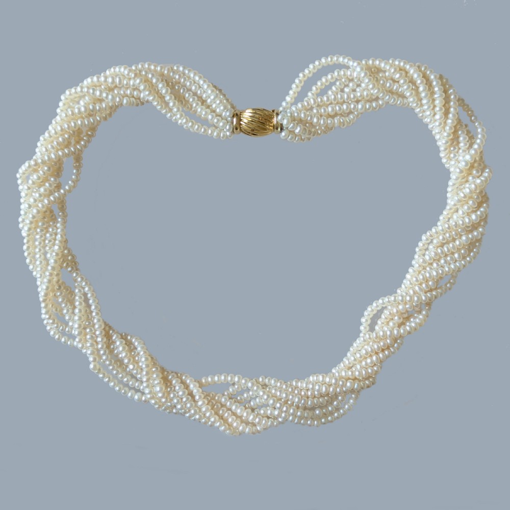 An eight-strand freshwater seed pearl necklace with a fluted yellow gold barrel clasp. View VI