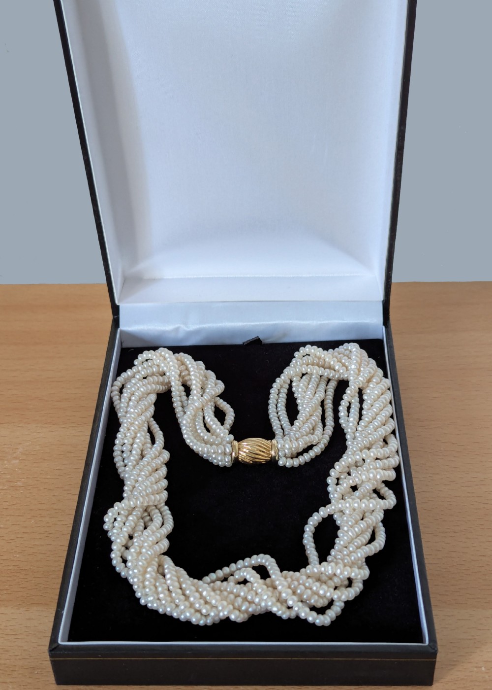 An eight-strand freshwater seed pearl necklace with a fluted yellow gold barrel clasp. View VII