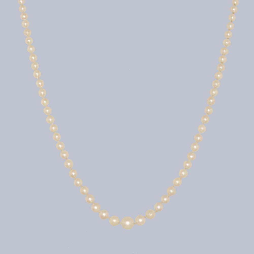 A single strand of cream cultured pearls featuring an oval purple amethyst mounted in a 9ct gold clasp surrounded by small pearls. View III