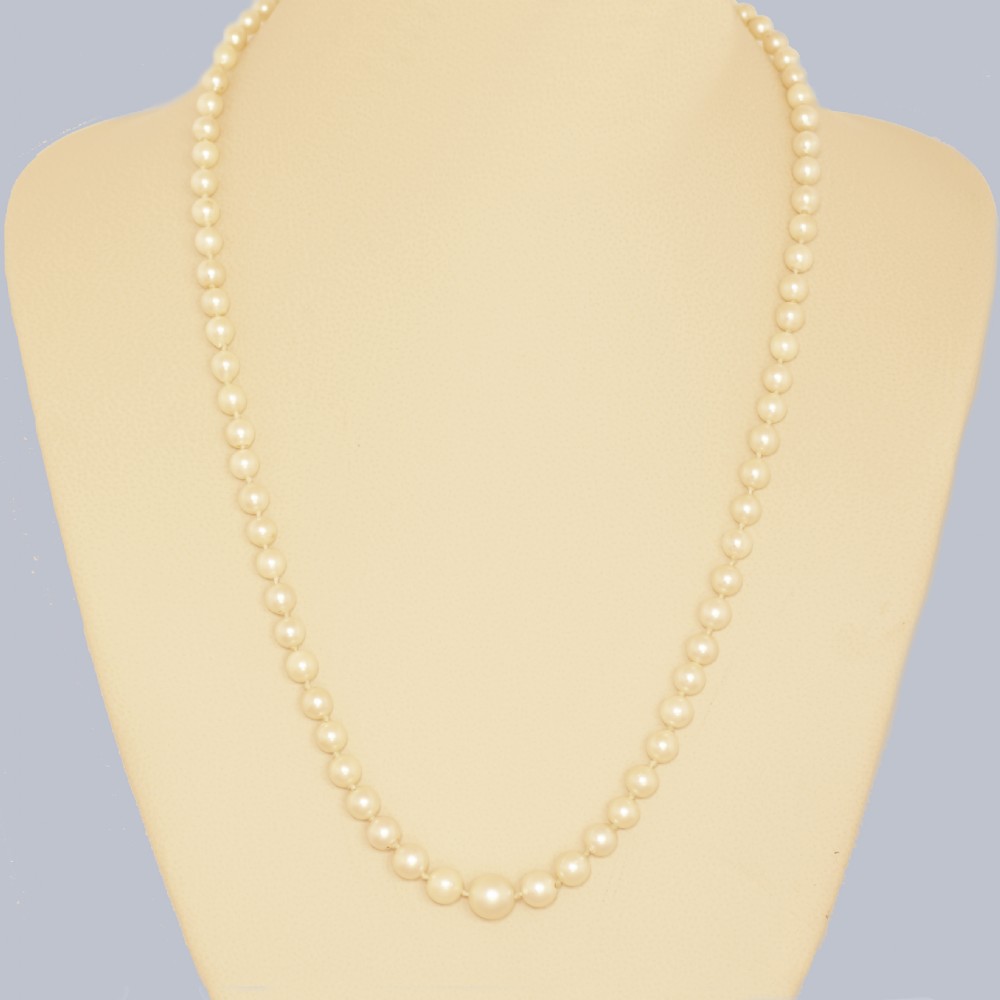 A single strand of cream cultured pearls featuring an oval purple amethyst mounted in a 9ct gold clasp surrounded by small pearls. View VII