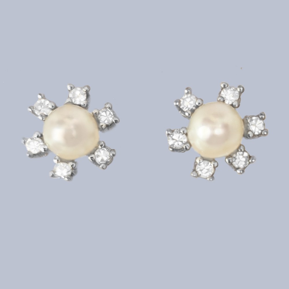 A pair of 18ct white gold stud earrings featuring a central cream pearl surrounded by six claw-set diamonds in a floral cluster arrangement.