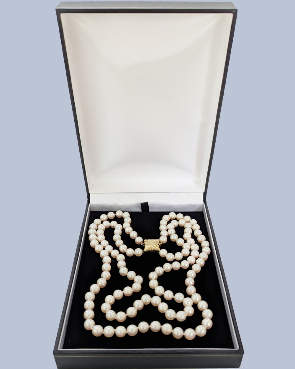 A double strand cultured pearl necklace featuring a square textured gold clasp embellished with diamonds. View VI