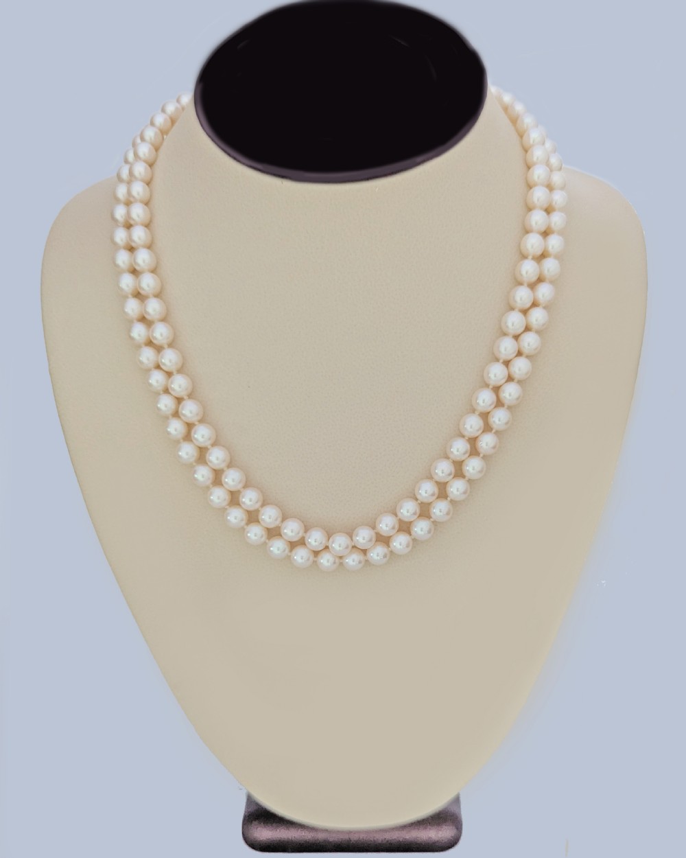 A double strand cultured pearl necklace featuring a square textured gold clasp embellished with diamonds. View VII