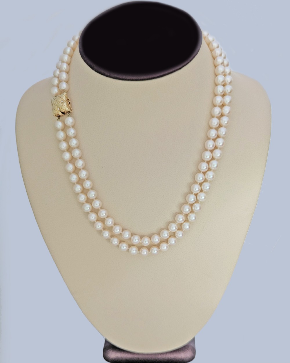 A double strand cultured pearl necklace featuring a square textured gold clasp embellished with diamonds. View VIII