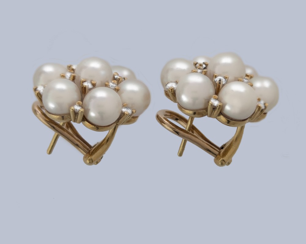 A pair of 1960s 18ct gold flowerhead cluster earrings set with central and surrounding cream pearls interspersed with diamond accents. View XI