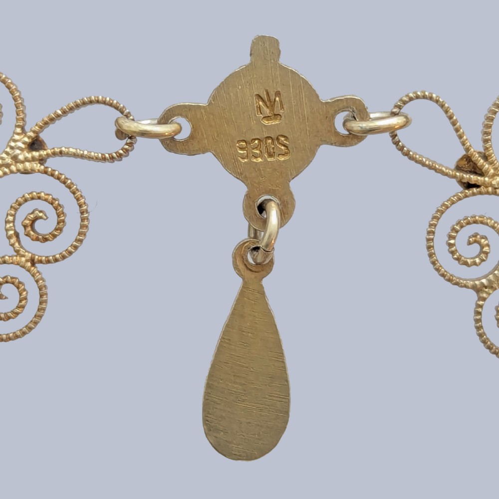 An Art Nouveau silver gilt festoon necklace featuring filigree scrollwork, turquoise guilloche enamel discs, and suspended teardrop pendants. View IV